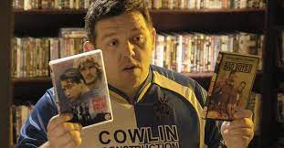 Danny Butterman from the film Hot Fuzz holds up dvds of Point Break and Bad Boys 2